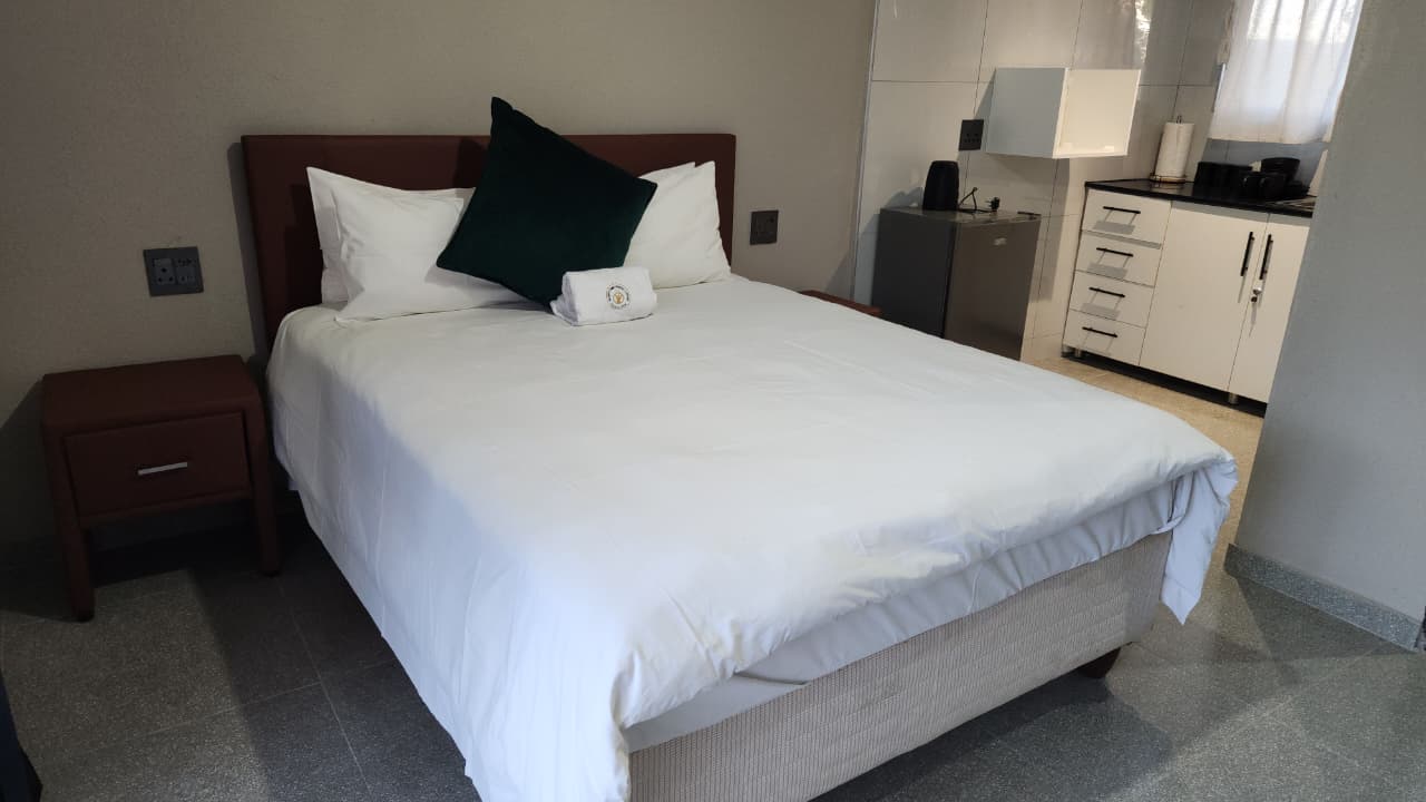 Suite 1 - full room view with bed, kitchenette and natural light