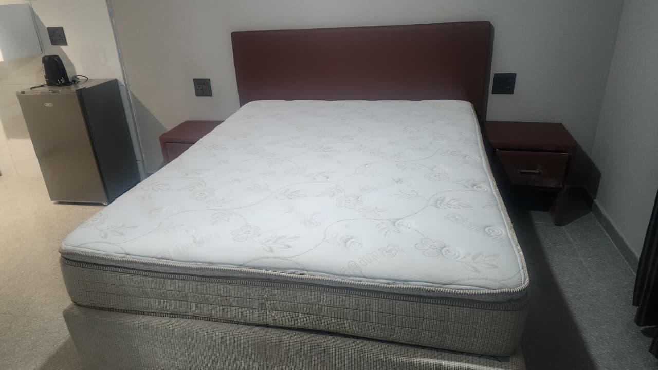 Close-up of queen bed with luxury linens